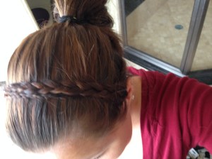 Grab a section of hair from the top of your ear to behind it and braid down. Secure with a small elastic. Do the same for the other side. Pull rest of hair back into a bun or pony tail and secure with elastic. Take one piece of braided hair and pull over top of head, secure with a bobby pin on other side. Do the same for the other braid, keeping it behind the first one you did. This makes it look wide and as if it were one piece. Voila! Homestead High Fashion :)