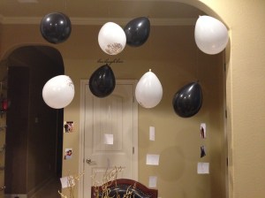 If you don't want to use helium, use fishing line to hang balloons and a few pictures of family and friends throughout the year! Floating auld lang syne!